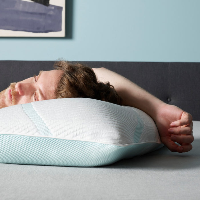 Man laying on a Tempur Pedic bed and pillow