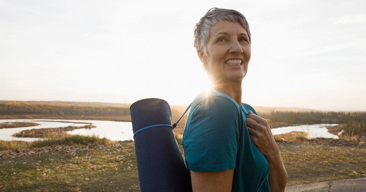 Woman holding yoga mat