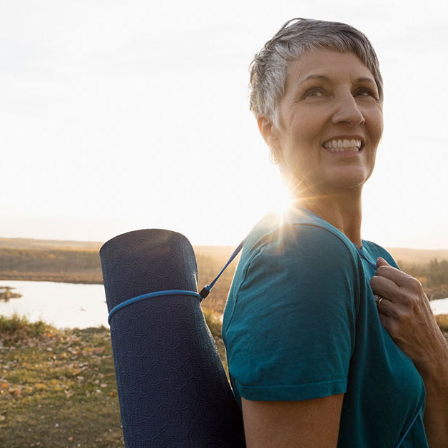 Woman holding yoga mat