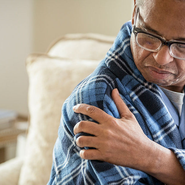 Man holding his shoulder