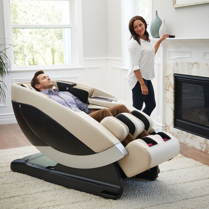 Man using a massage chair and a woman is standing next to him