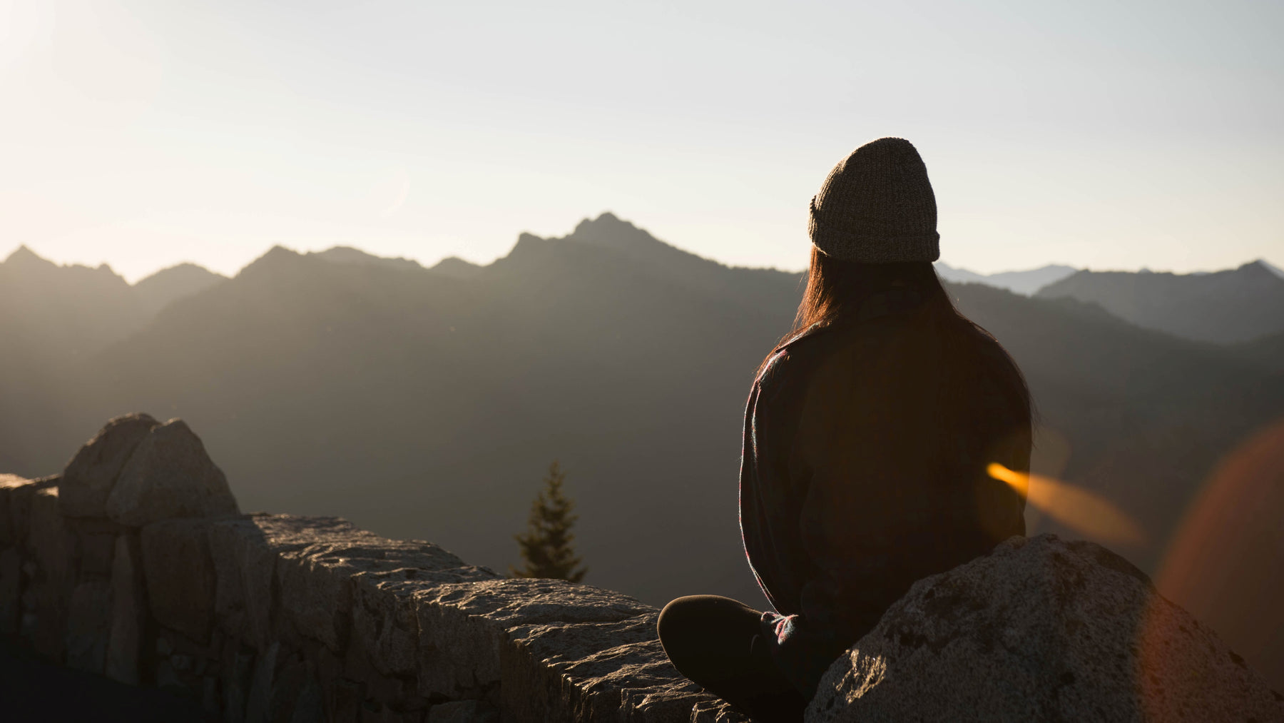 Woman sitting on a mountain looking at the view