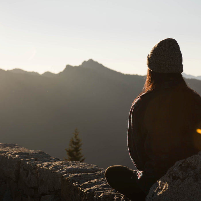 Woman sitting on a mountain looking at the view