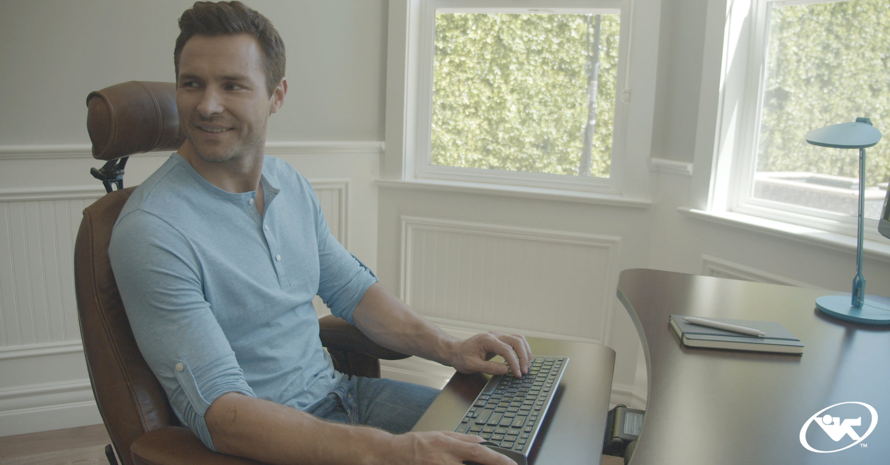 Man sitting on a Mid Back Executive Office Chair by Lifeform at his desk