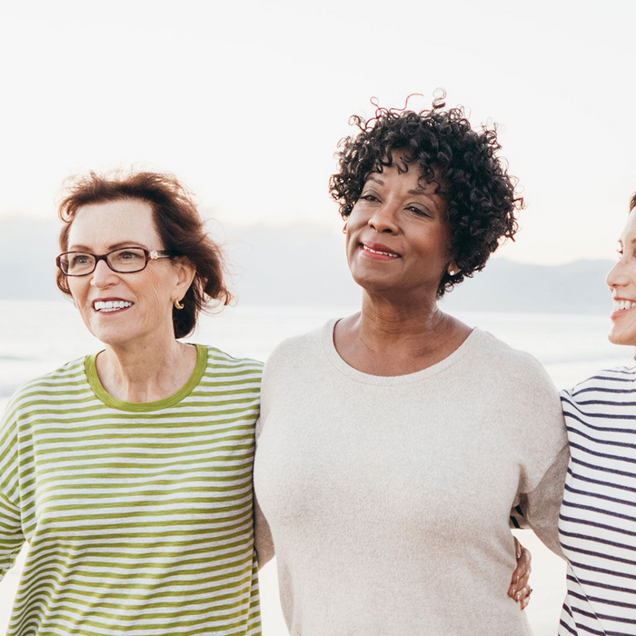 Three women walking on a beach