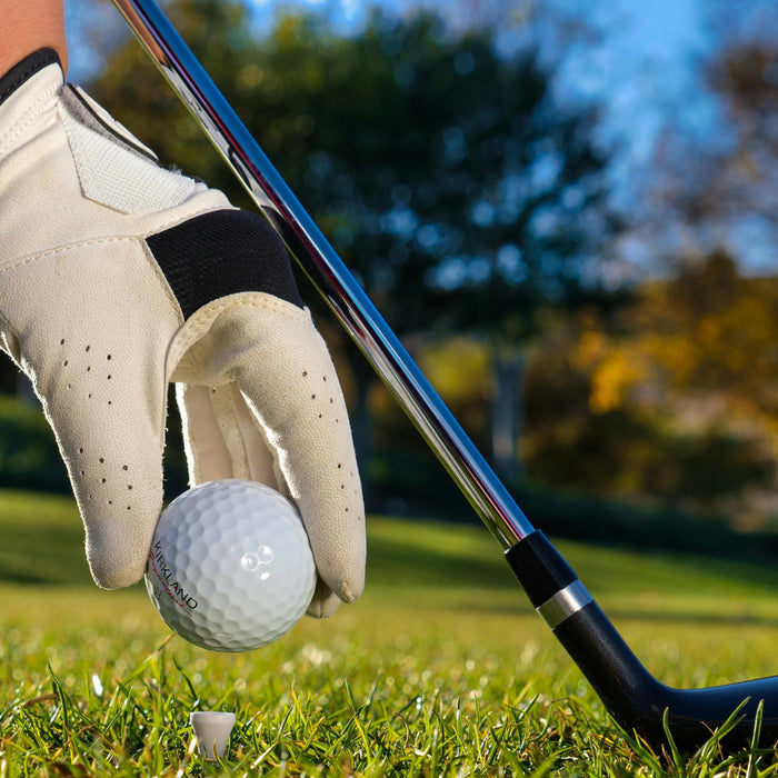 Golfer putting the ball on a tee. 