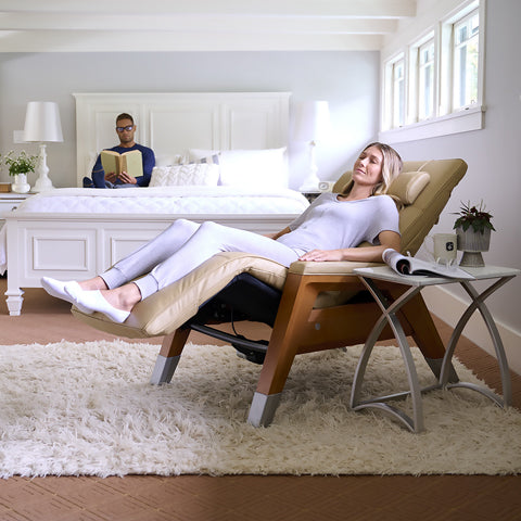 A woman sitting on the Gravis Zero Gravity Recliner in her bedroom.