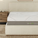 A close up of the A front view of the GhostBed Massage 12" Hybrid Mattress while in a bedroom setting.