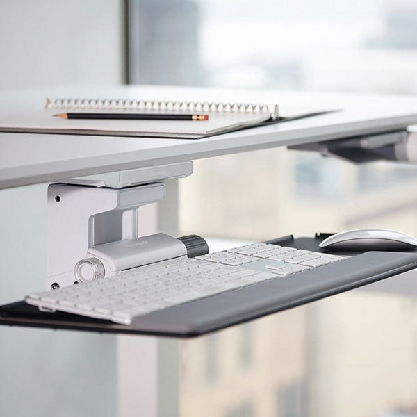 Float Desk Keyboard shown under a desk in an office